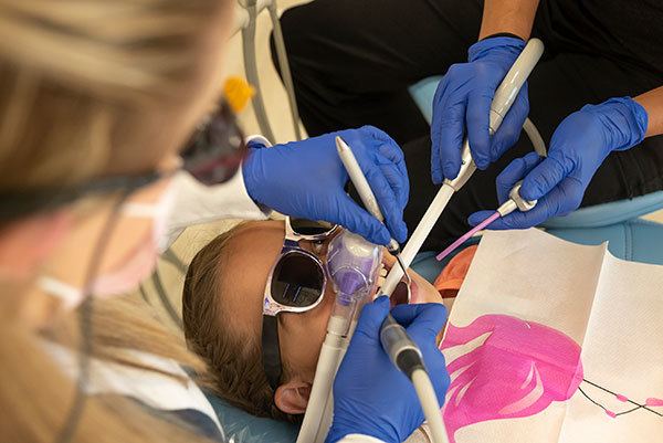 child receiving dental cleaning